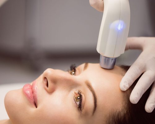 Female patient receiving cosmetic treatment at clinic
