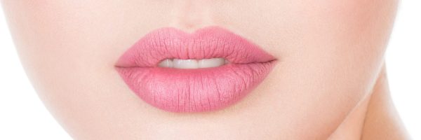 Young beautiful woman with health face. Beauty treatment concept. Skin care. Pretty girl with fresh skin of body. Young female touches cheek by fingers.